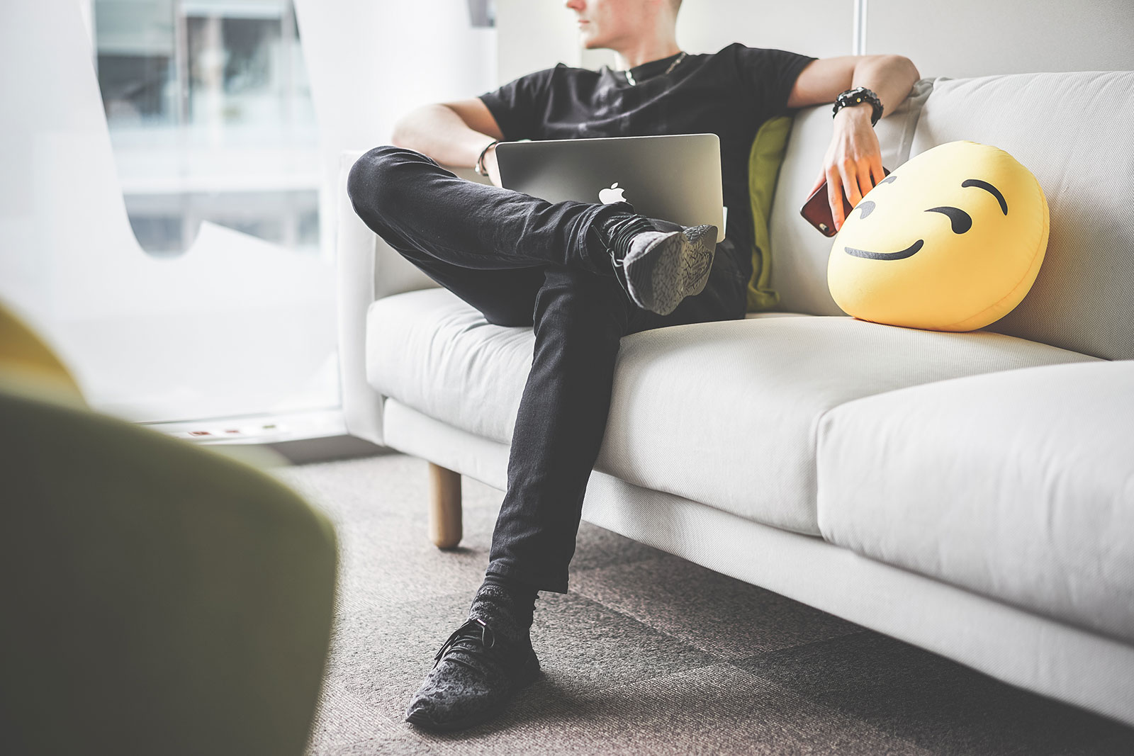 Young Man Thinking & Working with Laptop in Office Space